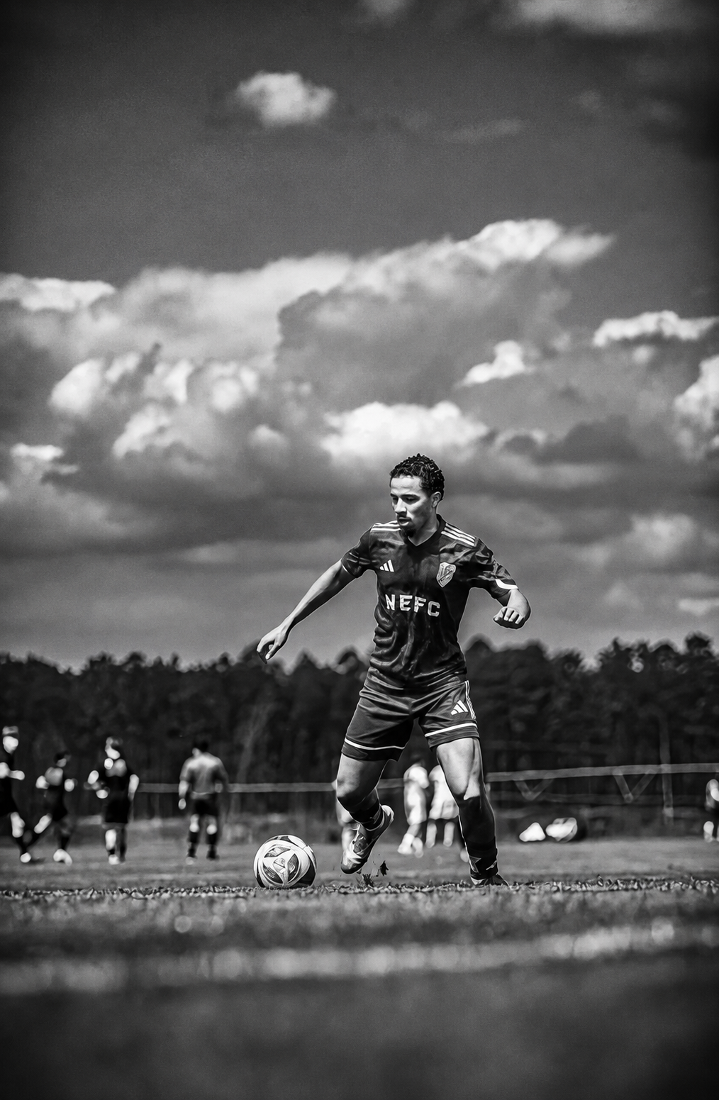 Levi Asher Goncalves running with the ball on the pitch